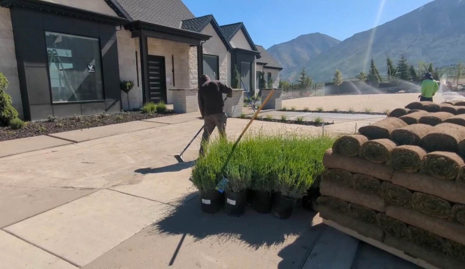 Frederico crew installing a finished landscape and walking through the completed space with the client